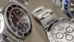 Close-up view of multiple Rolex watches with stainless steel bands.