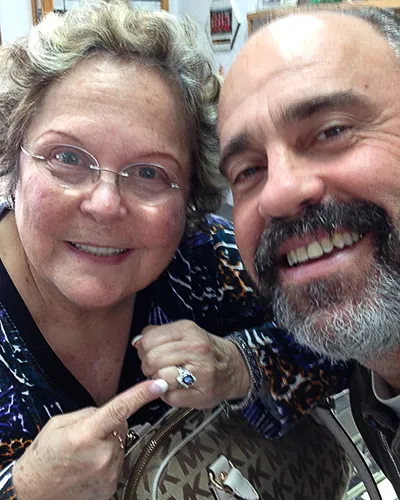 Paul Potenza of Design One Jewelers smiling with a satisfied customer in the Clearwater store.